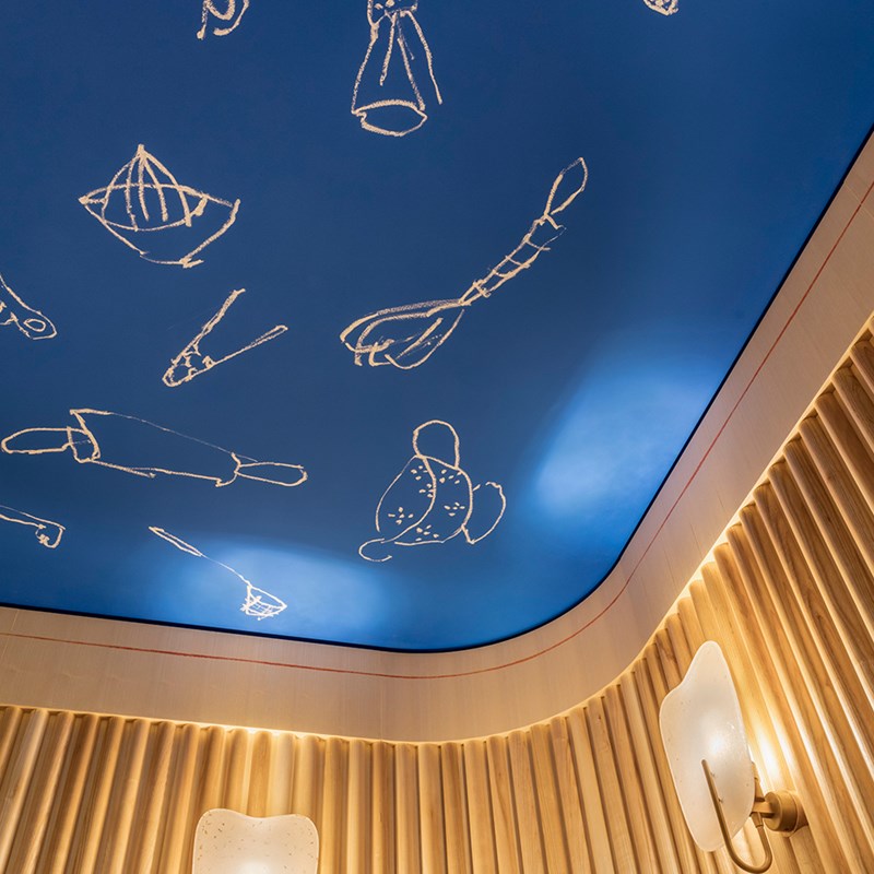View of the stunning ceiling art designed by Rochegaussen, at The Chef's Table.