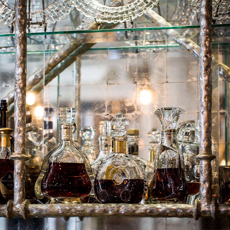 3 glass decanters of spirits on a shelf